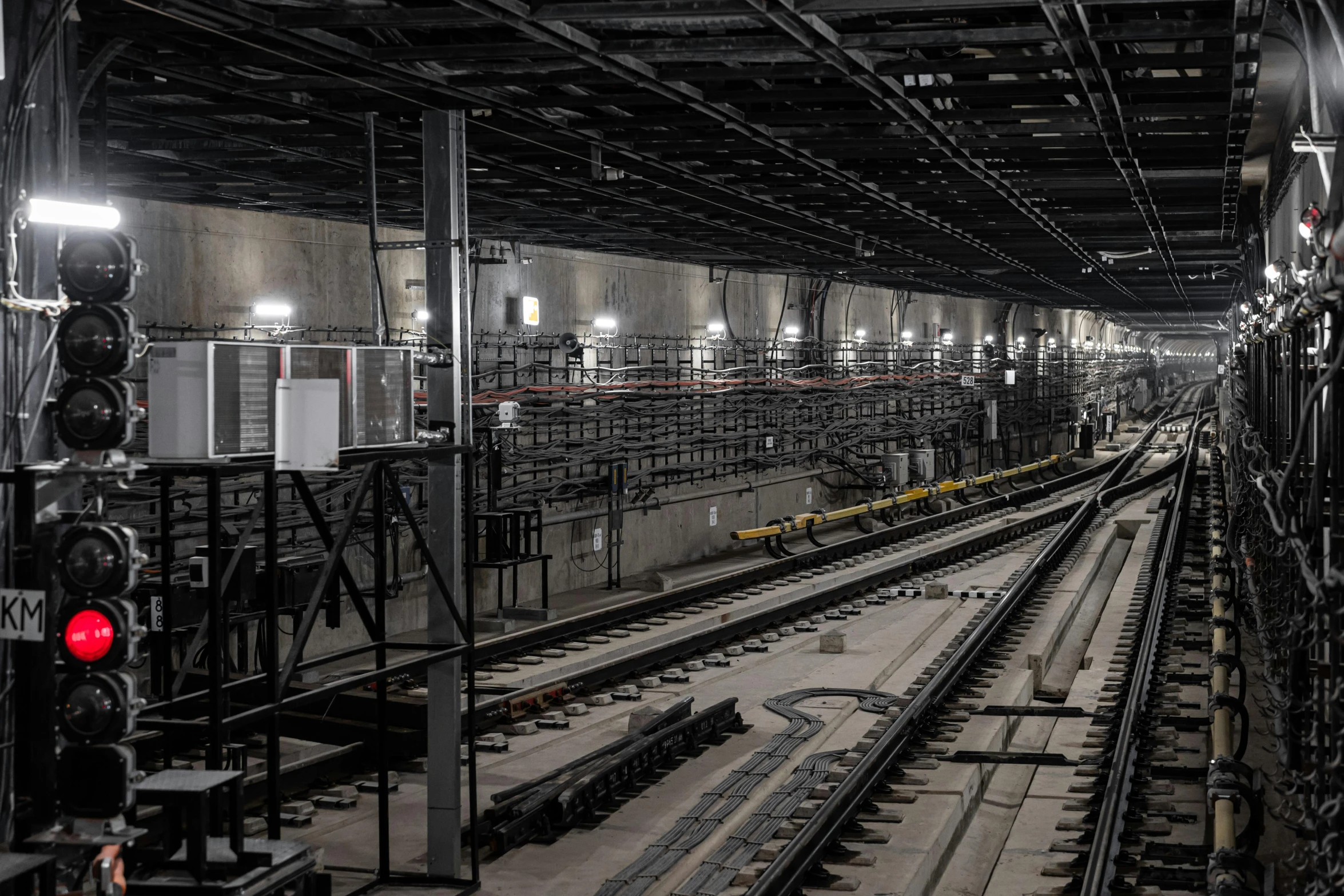 a train station filled with lots of train tracks, inspired by Thomas Struth, unsplash, underground lab, inside a warehouse, promo image, under construction