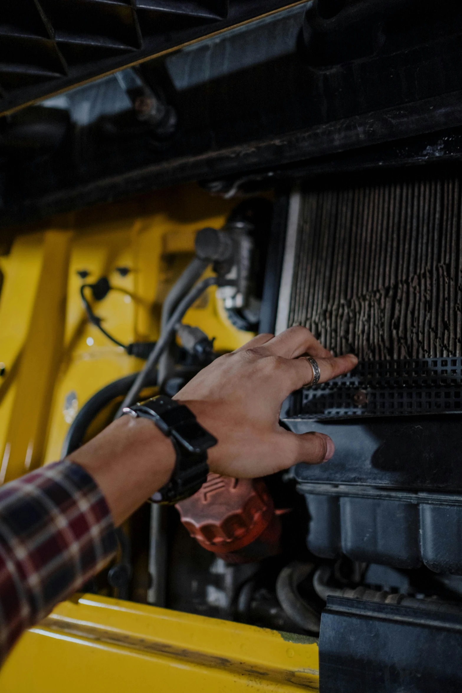 a close up of a person touching a radiator, by Dan Content, truck, yellow, diagnostics, technologies