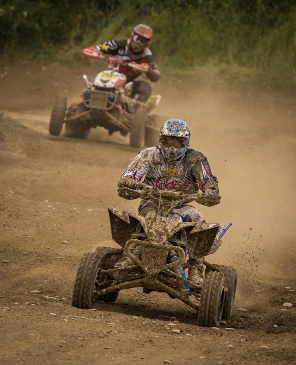 a couple of people riding atvs down a dirt road, by Adam Marczyński, pexels contest winner, process art, massive vertical grand prix race, splash image, sport, panels