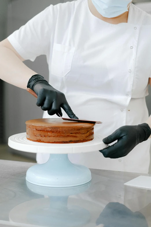 a woman in a white shirt and black gloves cutting a cake, silicone skin, thumbnail, black, brown