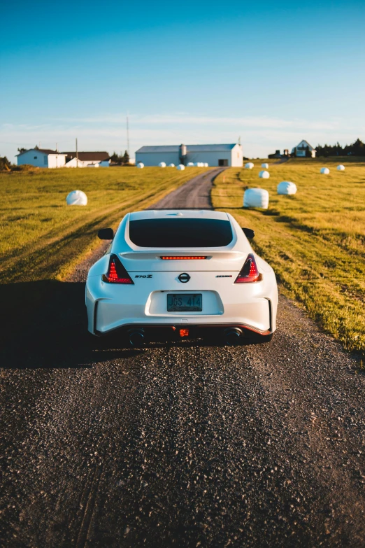 a white car parked on the side of a road, by Matt Cavotta, pexels contest winner, arched back, jdm, in the middle of a field, sports car in the room