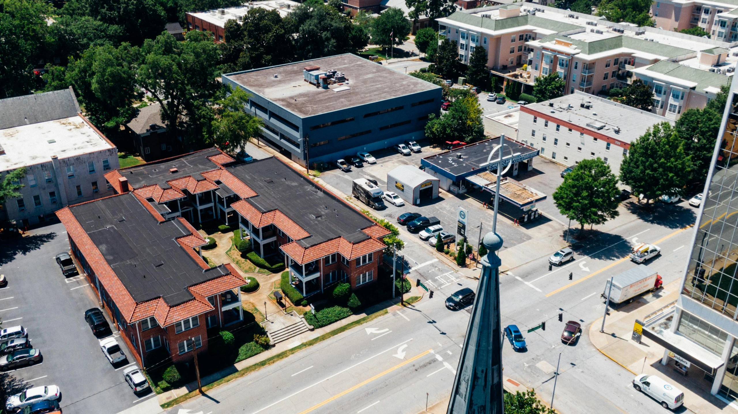 an aerial view of a city with a church steeple, by Carey Morris, ultrastation hq, walton's five and dime, view from the street, on a sunny day