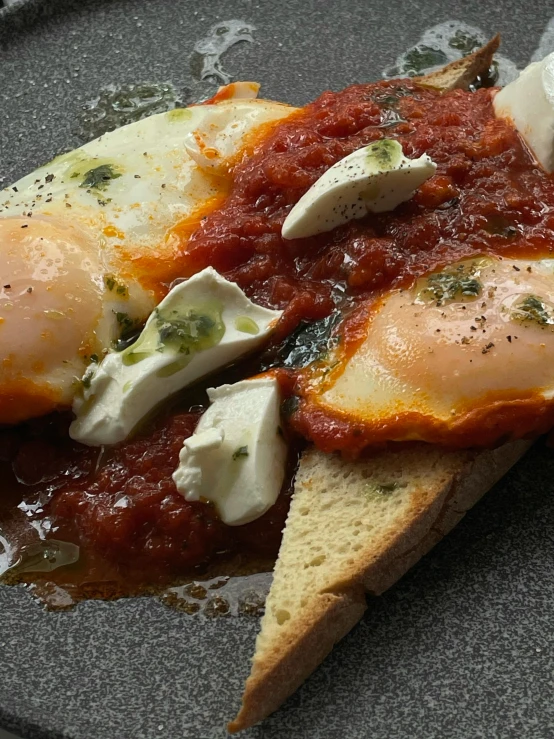 a close up of a plate of food on a table, eggs, tomato sauce, pointè pose, plenty mozzarella