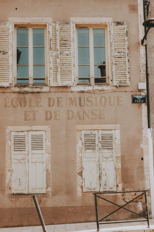 an old building with shutters on the windows, an album cover, pexels contest winner, paris school, taupe, sign, dance, unsplash contest winning photo