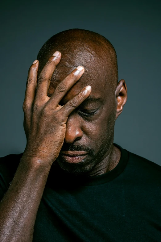 a man holding his head in his hands, an album cover, inspired by Terrell James, pexels, lance reddick, distraught, ptsd, portrait of gigachad