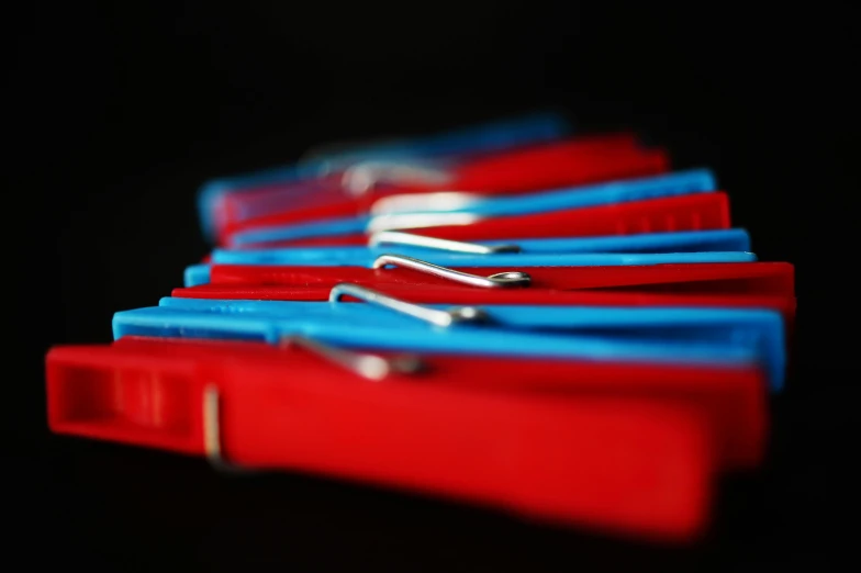 a bunch of red and blue clothes pins, by Stefan Gierowski, flickr, low key, shot on sony a 7 iii, leather straps, cardistry
