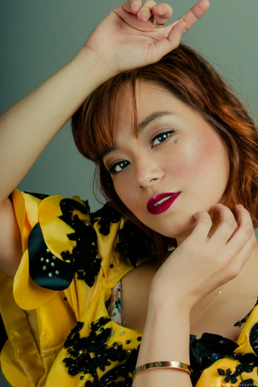 a woman in a yellow dress posing for a picture, a portrait, inspired by Yuko Tatsushima, trending on pexels, a redheaded young woman, promotional image, ana de la reguera portrait, asian woman