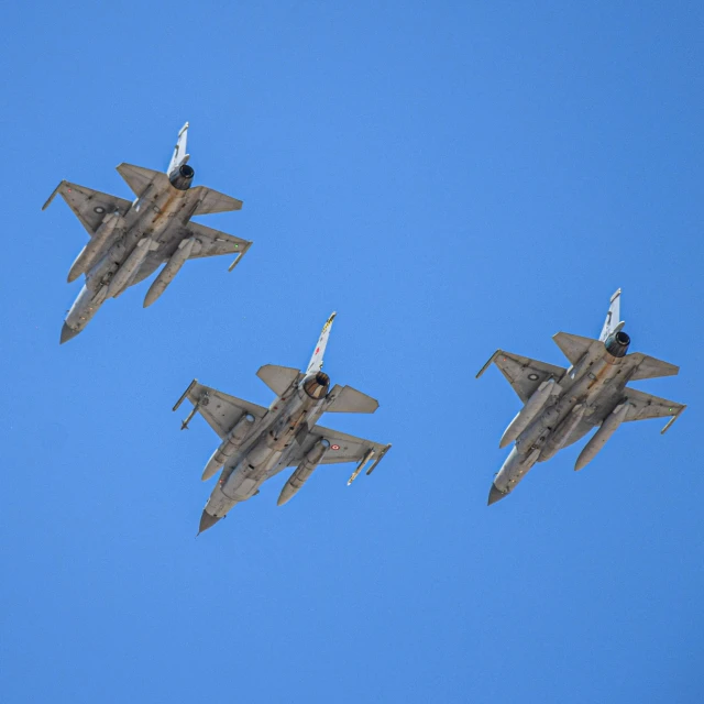 a group of fighter jets flying through a blue sky, by Steven Belledin, pexels, three towers, jerez, highly ornate, brown