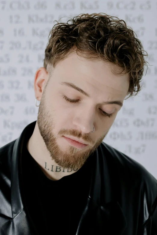 a man in a leather jacket looking at a cell phone, an album cover, inspired by Adam Szentpétery, trending on pexels, antipodeans, he has short curly brown hair, artem, face close up, an all white human