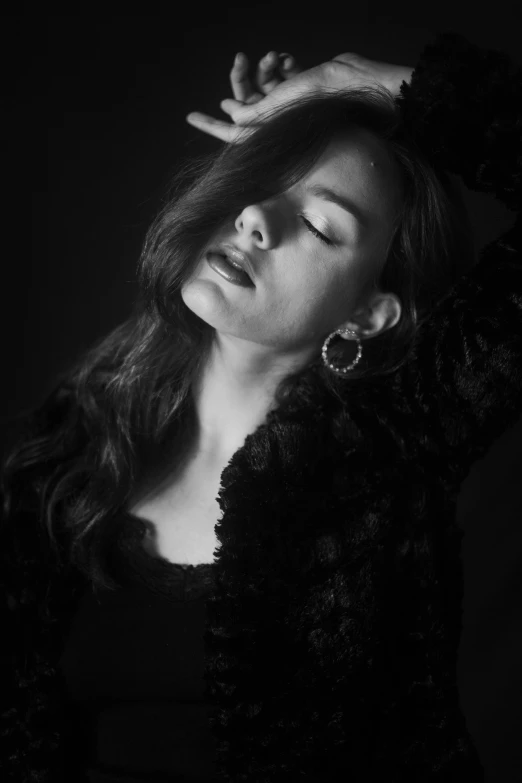 a black and white photo of a woman in a fur coat, a black and white photo, pexels contest winner, photorealism, vocalist, young sensual woman, ✨🕌🌙, icon black and white