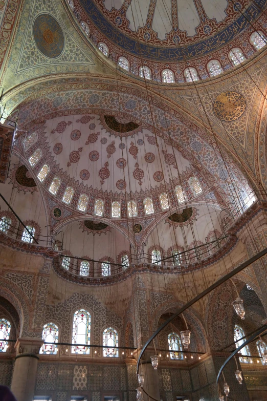 a group of people standing inside of a building, a mosaic, arabesque, black domes and spires, rounded ceiling, 2 5 6 x 2 5 6, wikipedia