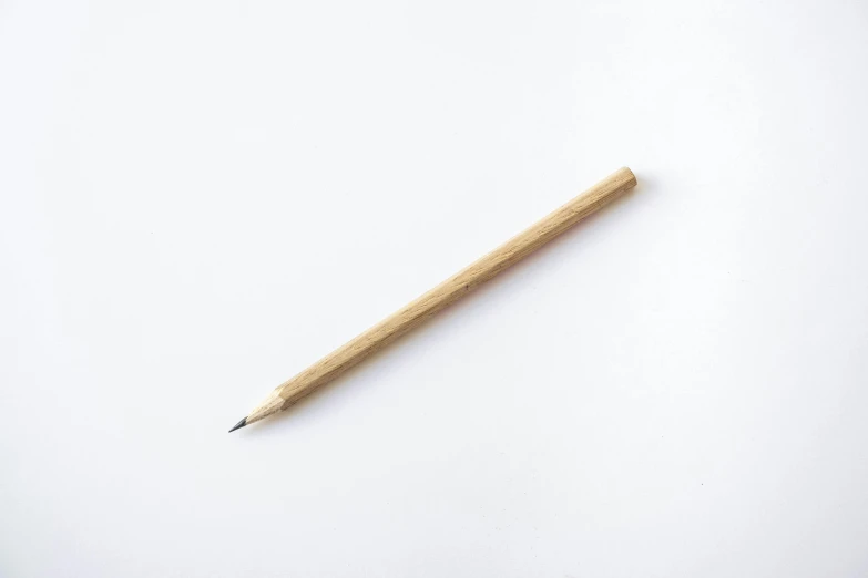 a pencil sitting on top of a white surface, made of bamboo, ignant, thumbnail, from the front