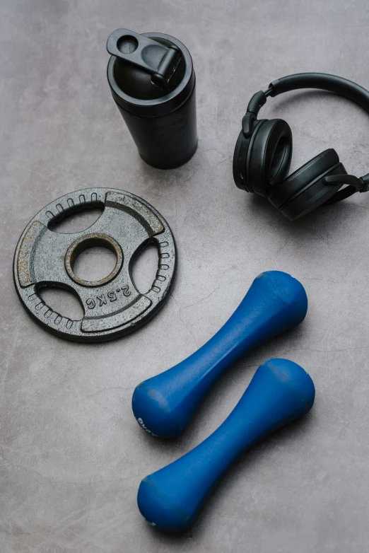 a pair of headphones sitting on top of a table, a still life, by Jan Cox, unsplash, dau-al-set, carrying two barbells, black and blue scheme, blue - grey gear, thumbnail