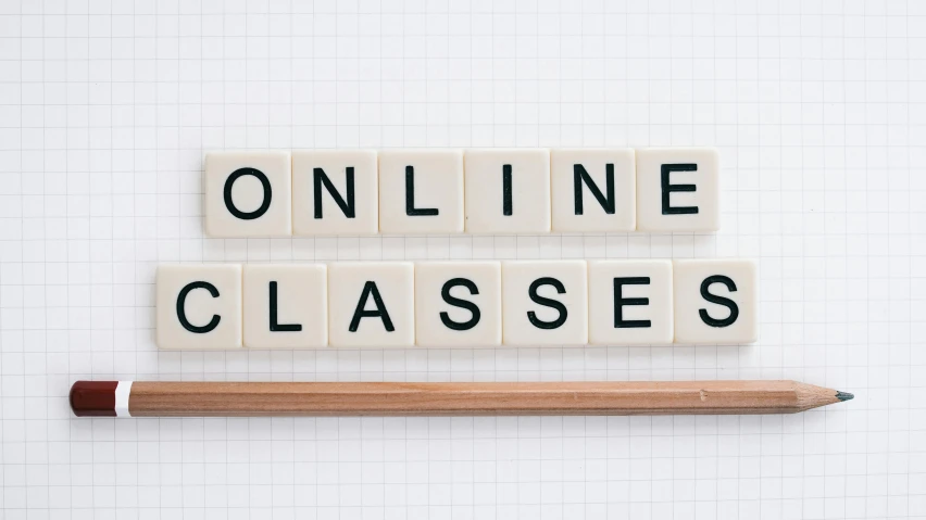 a pencil sitting next to a block with the word online classes written on it, a photo, academic art, plain background, profile image, no - text no - logo, background image