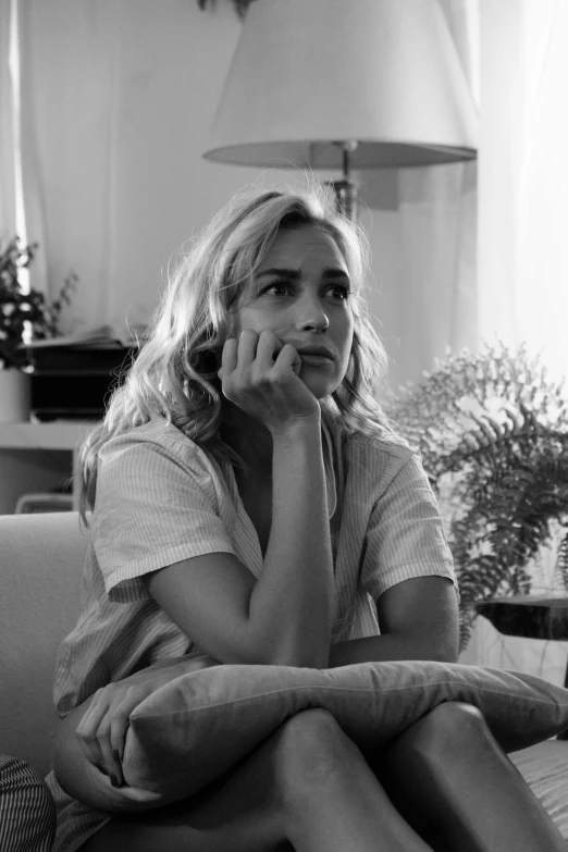 a woman sitting on a couch talking on a cell phone, a black and white photo, by Henri-Julien Dumont, reddit, happening, portrait of kim wexler, gif, summer morning, heartbroken