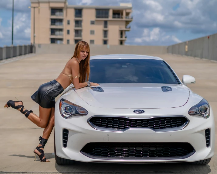 a woman leaning on the hood of a white car, pexels contest winner, kia soul, muscle cars, full body cute young lady, bella poarch
