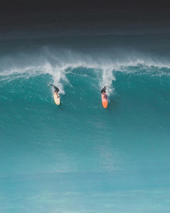 a couple of people riding a wave on top of surfboards, by Robbie Trevino, pexels contest winner, wall of water either side, o'neill cylinder colony, orange and teal color, slide show