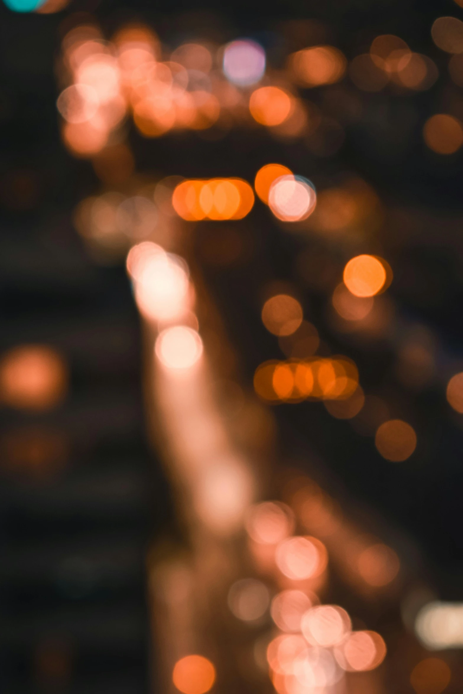 a blurry photo of a city at night, unsplash contest winner, light and space, overcast bokeh - c 5, orange lights, macro bokeh ”