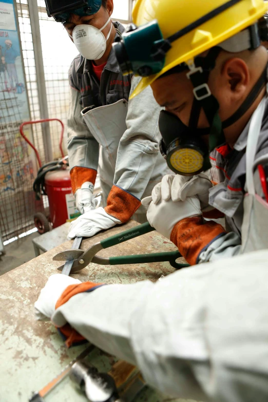 a group of men in protective gear working on a piece of wood, hong kong, slide show, terrazzo, metal readymade