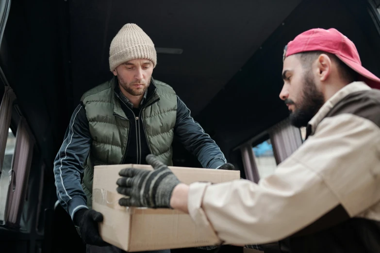 two men unloading boxes in the back of a truck, pexels contest winner, hurufiyya, he also wears a grey beanie, avatar image, caucasian, reassuring