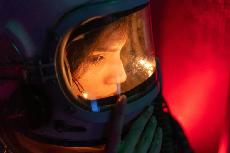 a close up of a person in a space suit, a portrait, inspired by Elsa Bleda, pexels contest winner, girl looks at the space, gemma chan, natalia dyer, red and cinematic lighting