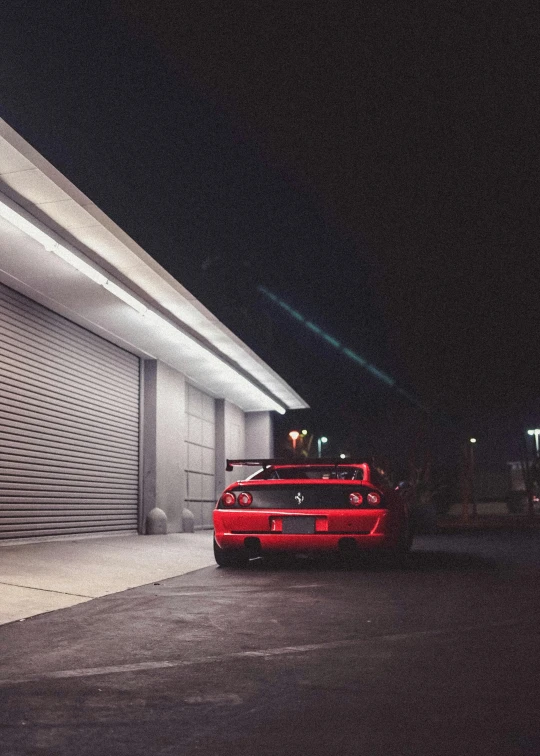 a red sports car parked in front of a garage, inspired by Hiroshi Honda, unsplash, conceptual art, night time footage, 2000s photo, snapchat photo, f4”