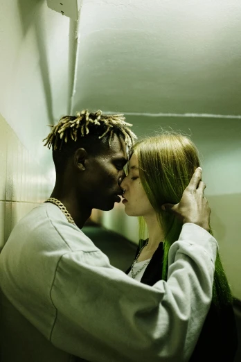 a man and a woman kissing in a hallway, inspired by Elsa Bleda, trending on pexels, bright green hair, adut akech, playboi carti, press shot