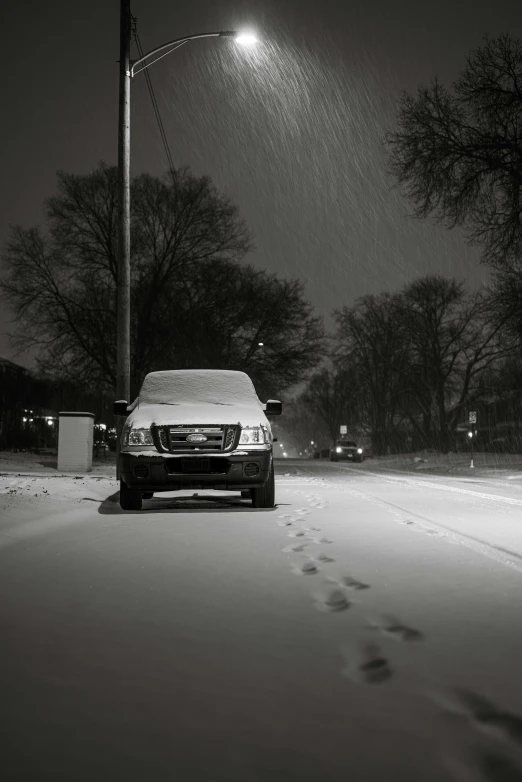 a black and white photo of a car in the snow, by Andrew Domachowski, flickr, minneapolis, late evening, ffffound, van