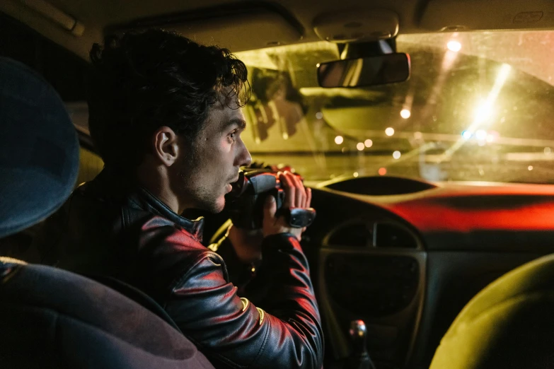 a man sitting in a car talking on a cell phone, by Adam Marczyński, pexels contest winner, happening, nightcap, robert sheehan, drinking, high speed chase