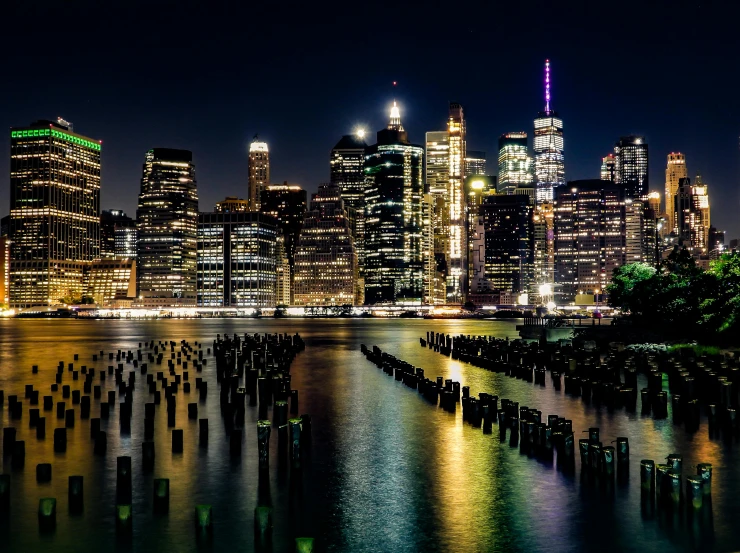 the city skyline is lit up at night, a colorized photo, pexels contest winner, ny, a wooden, post processed, bioluminescent