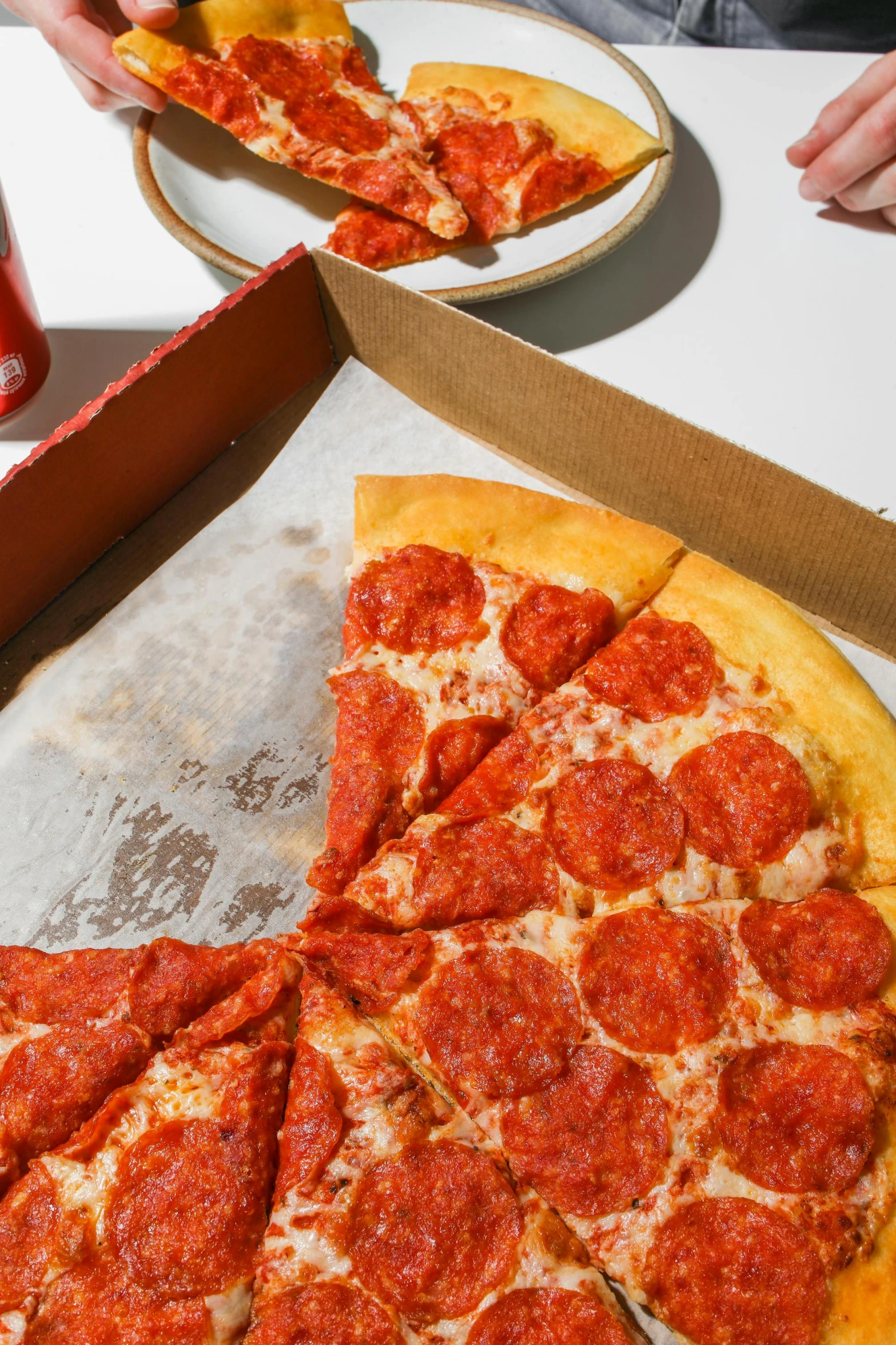 a pepperoni pizza sitting on top of a table, all red, 3 - piece, sharing a pizza, zoomed out shot