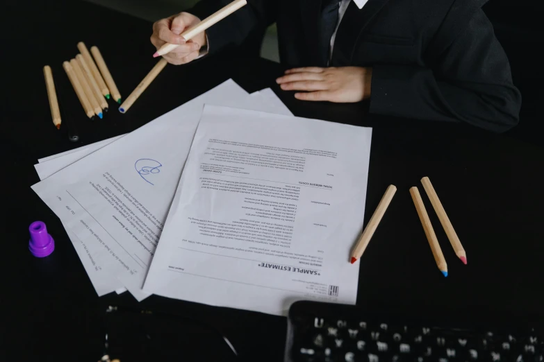 a man in a suit sitting at a desk with papers and pencils, by Adam Marczyński, pexels contest winner, avatar image, background image, instagram post, a person standing in front of a