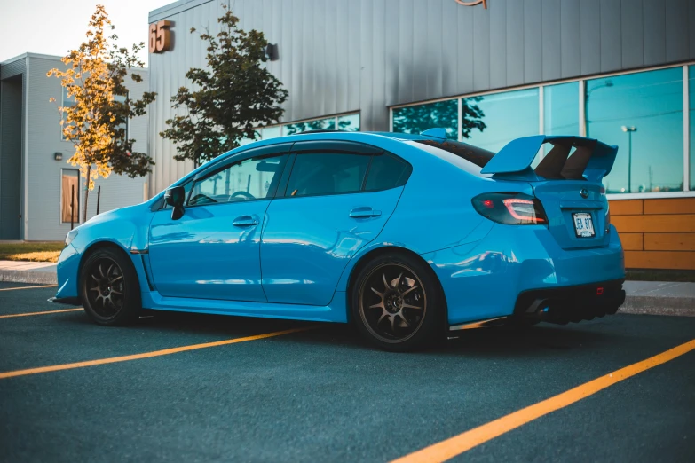 a blue car parked in front of a building, inspired by An Gyeon, pexels contest winner, wrx golf, right side profile, samurai vinyl wrap, perfect coloring