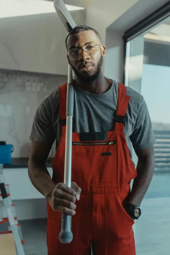 a man standing in a room holding a mop, inspired by Paul Georges, pexels contest winner, portrait of lebron james, mechanic, low quality video, ( ( theatrical ) )