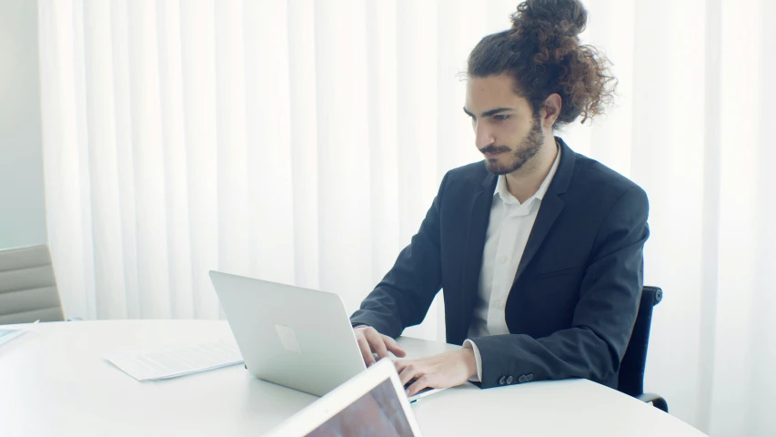 a man sitting at a table using a laptop computer, pexels contest winner, wearing business casual dress, avatar image, shabab alizadeh, lachlan bailey