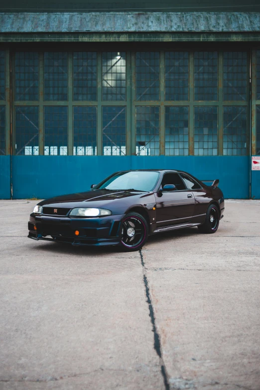 a black car parked in front of a building, pexels contest winner, realism, japanese drift car, profile image, 1990's, frontal pose