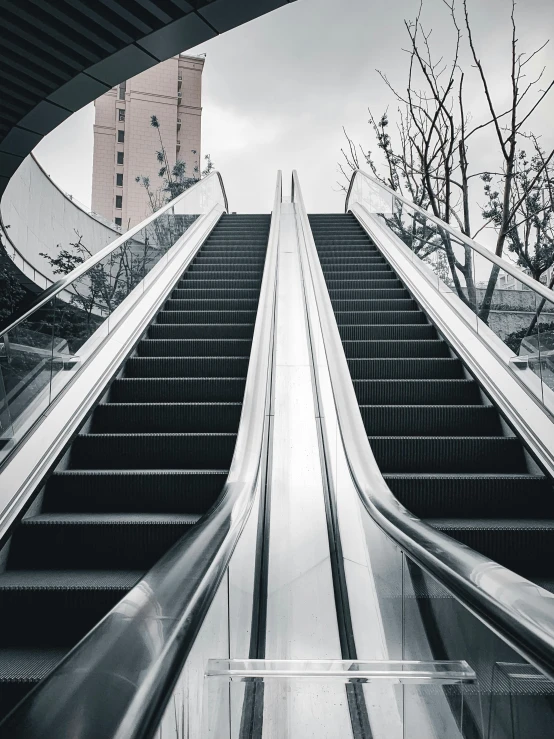 a black and white photo of an escalator, an album cover, pexels contest winner, hypermodernism, instagram story, in the middle of the city, 🚿🗝📝, two stories