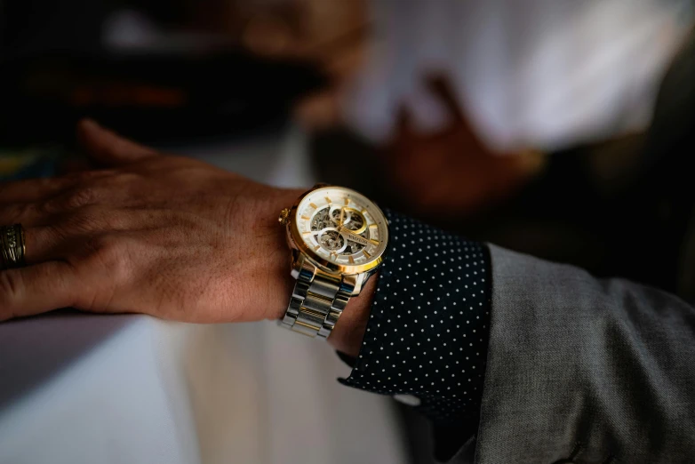 a close up of a person wearing a watch, pexels contest winner, formal attire, silver white and gold, animation, multiple stories