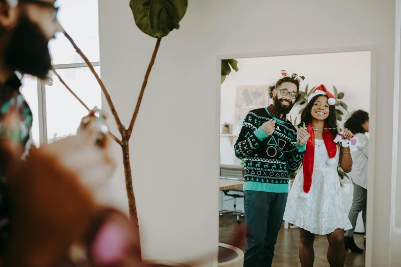 a man and woman standing next to each other in a room, pexels contest winner, wearing festive clothing, avatar image, playful composition, mid shot photo