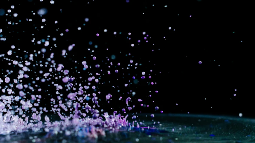 a close up of water with bubbles coming out of it, by Niko Henrichon, unsplash, digital art, purple volumetric lighting, confetti, ground - level medium shot, with a black background