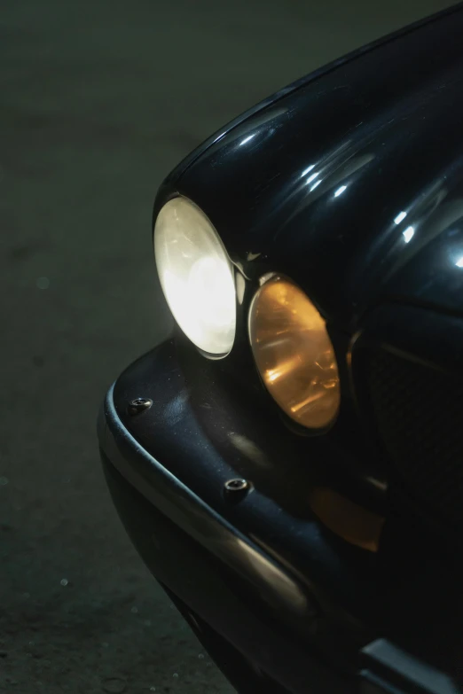 a close up of the headlights of a car, an album cover, unsplash, photorealism, close up 1 9 9 0, cinestill 800t 35mm eastmancolor, ( ( ( ( ( jaguar e - type car, pinhole analogue photo quality