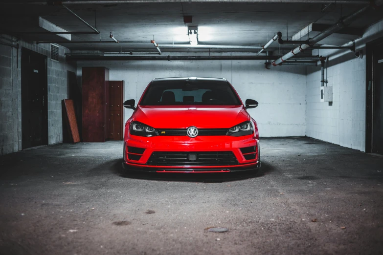 a red car parked in a parking garage, by Adam Marczyński, pexels contest winner, wrx golf, frontal pose, instagram post 4k, samurai vinyl wrap