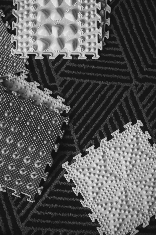 a black and white photo of a black and white quilt, a digital rendering, kinetic pointillism, softplay, rubber waffle outsole, zun, pentagon