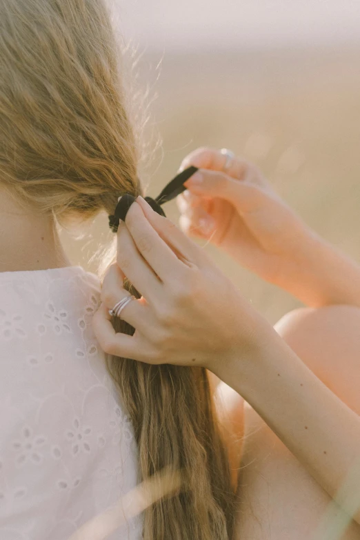 a woman combing another woman's hair in a field, by David Simpson, trending on unsplash, ribbon, rings, low detail, soft shadow transition