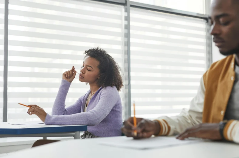 a couple of people that are sitting at a table, pexels contest winner, academic art, sat at her desk, pouting, aida muluneh, grading