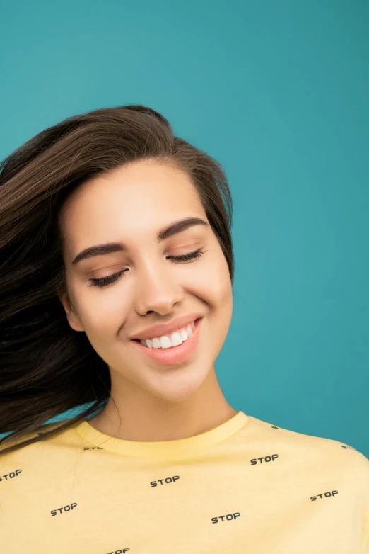 a woman with her hair blowing in the wind, trending on pexels, solid background, smiling :: attractive, smooth chin, promo image