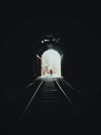 a person standing on a train track at the end of a tunnel, a picture, by Lucia Peka, unsplash contest winner, high contrast!, the tunnel into winter, single light, ilustration
