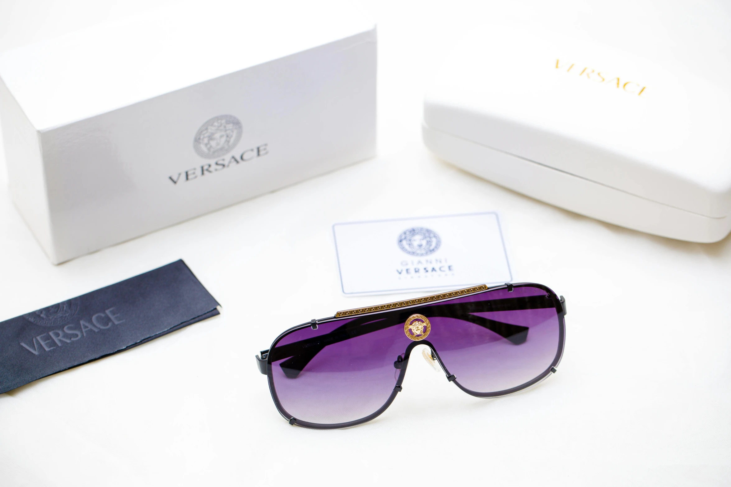 a pair of sunglasses sitting on top of a table, versace, ((purple)), high quality product image”, various items