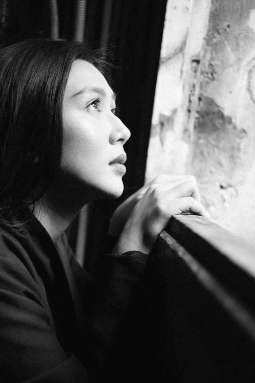 a black and white photo of a woman looking out a window, inspired by Xia Shuwen, young woman looking up, ((portrait)), promo image, keng lye