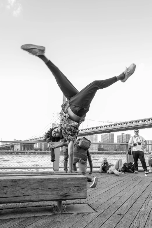 a black and white photo of a person doing a handstand, a black and white photo, happening, brooklyn, everyone having fun, shot with sony alpha, dynamic!!